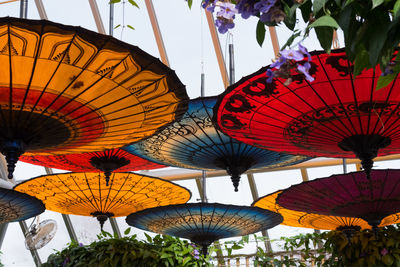 Low angle view of lanterns hanging against sky