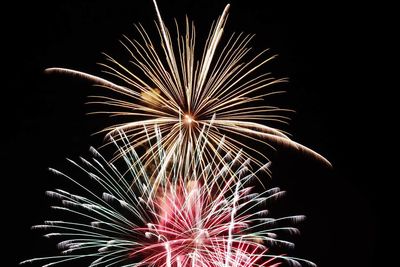 Low angle view of firework display against sky at night