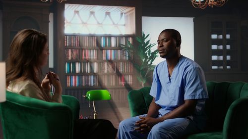 Side view of young woman sitting on sofa at home