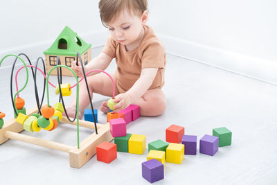 Boy playing with toy blocks on table