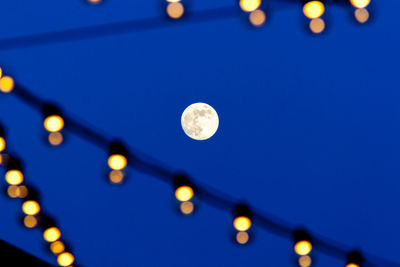 Low angle view of illuminated lights at night