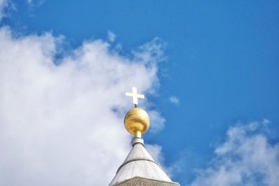 Low angle view of cross on building against sky