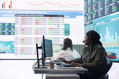 Businesswoman using laptop at office
