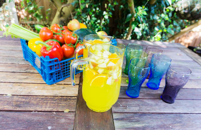 Close-up of drink by vegetables in crate