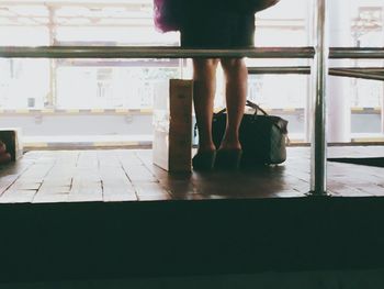 Low section of woman standing on tiled floor