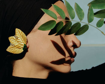 Close-up of woman with red flower