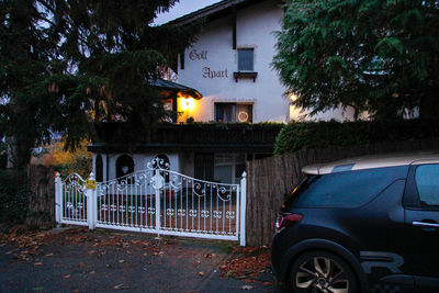 Illuminated house by building in city