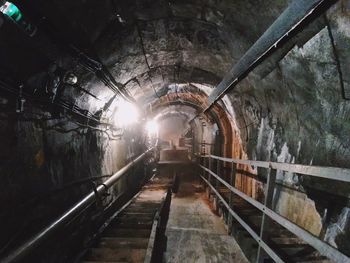 Rear view of man standing in tunnel