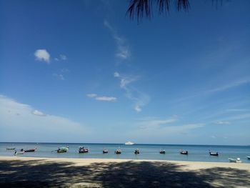 Scenic view of beach against blue sky