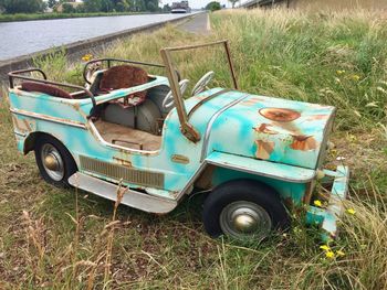 Abandoned car on field