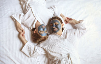 High angle view of woman lying on bed