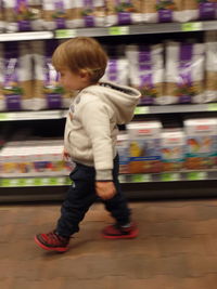 Rear view of boy walking on train at subway station