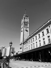 Low angle view of clock tower against sky in city