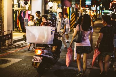 People walking on road in city at night