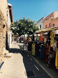 Street amidst buildings in city against sky