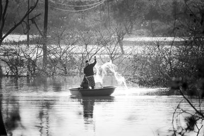 Man on boat in lake