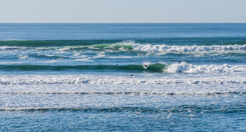 Waves suitable for surfing roll in at westport, washington.