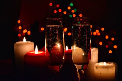 Close-up of illuminated candles on table