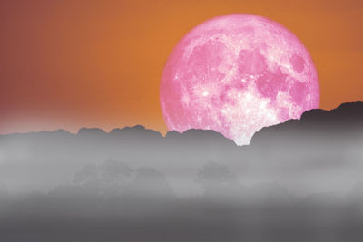 Scenic view of pink and mountains against sky during sunset