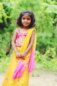 Portrait of a smiling girl standing outdoors