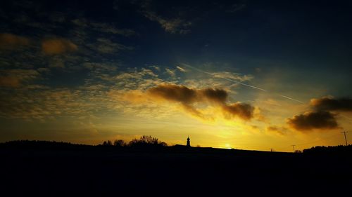 Silhouette trees against sky during sunset