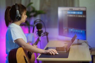 Woman singing while standing at home