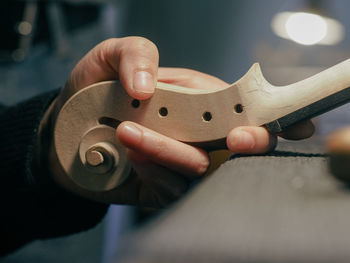 Luthier holding a classic violin scroll