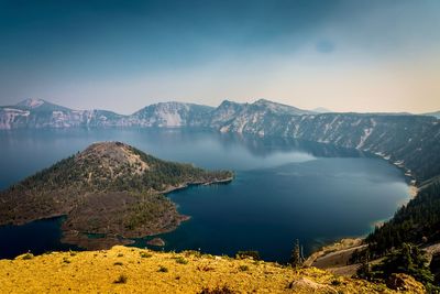 Scenic view of lake and mountains against sky