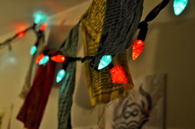 Low angle view of illuminated lights hanging on wall