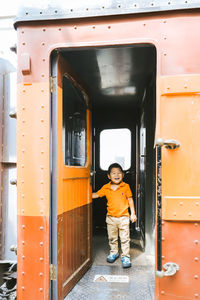 Full length portrait of boy on bus