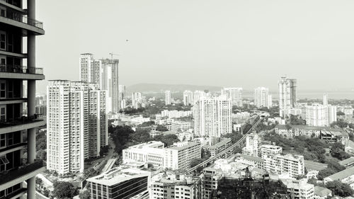 Modern buildings in city against clear sky