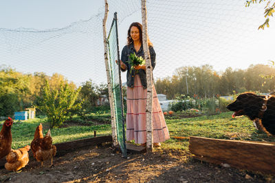 Side view of young woman sitting on field