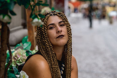 Portrait of young woman looking away outdoors