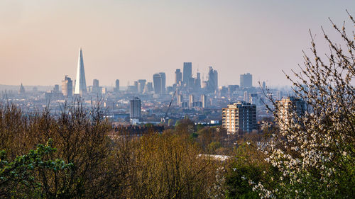 Buildings in city against clear sky