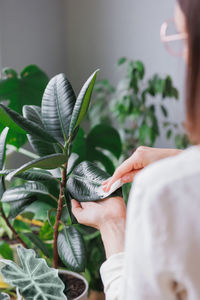 Midsection of woman holding plant