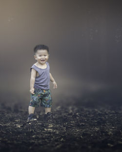 Portrait of cute baby boy standing on land