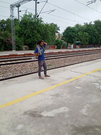 Full length of woman on railroad station platform