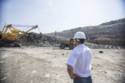 Rear view of man working at construction site