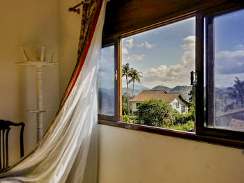 House against sky seen through window