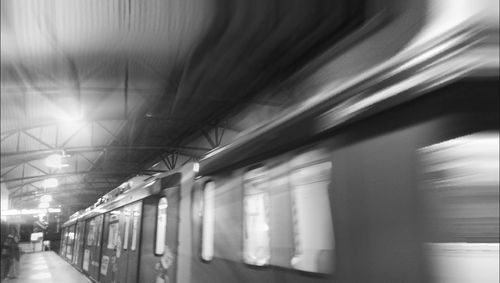 Train in illuminated underground walkway