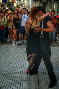 Full length of young woman sitting on table