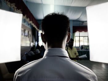 Rear view of man standing in studio