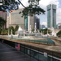 View of city street and buildings against sky