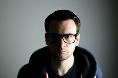 Close-up portrait of young man against white background