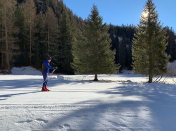 Full length of woman walking on snow covered land