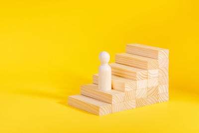 Close-up of toy blocks against yellow background