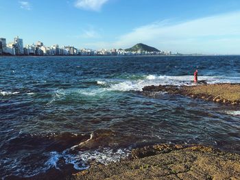 Scenic view of sea and buildings against sky