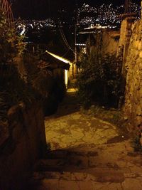 Illuminated walkway at night