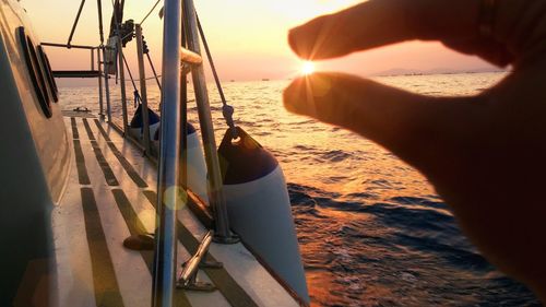 Close-up of hand on sailboat at beach