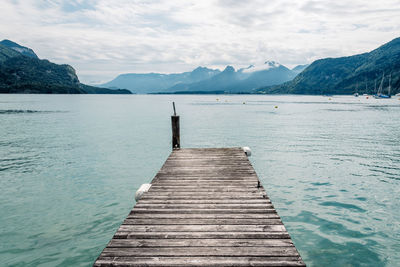 Pier over lake against sky